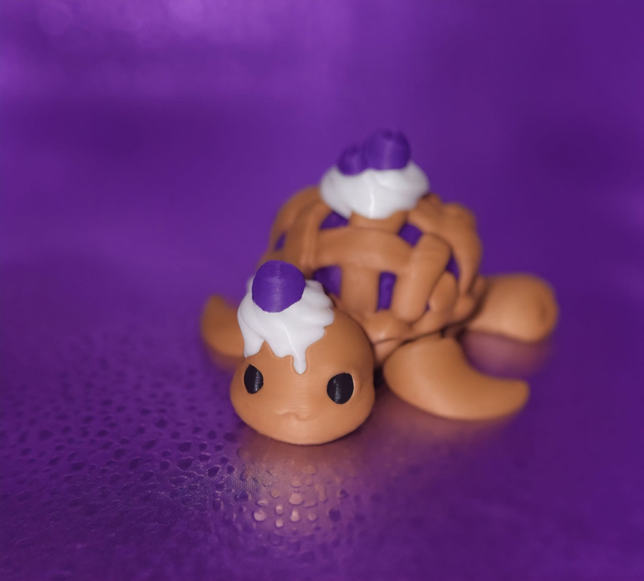 Articulated 3D printed turtle keyring with a blueberry cupcake shell