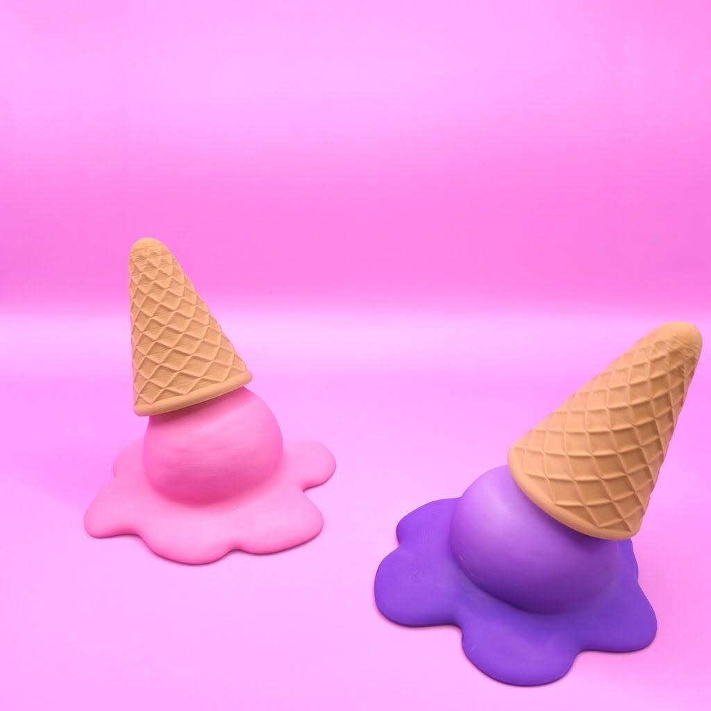 Two melting ice cream cone 3D printed keyrings in pink and purple